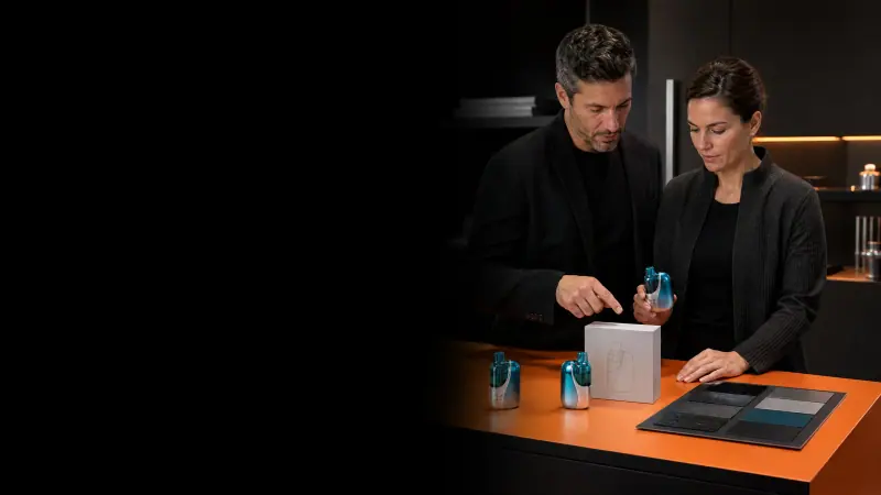 Two adults reviewing WINDBAR CHROMA WING samples on an orange lab bench (WindBar.ai)
