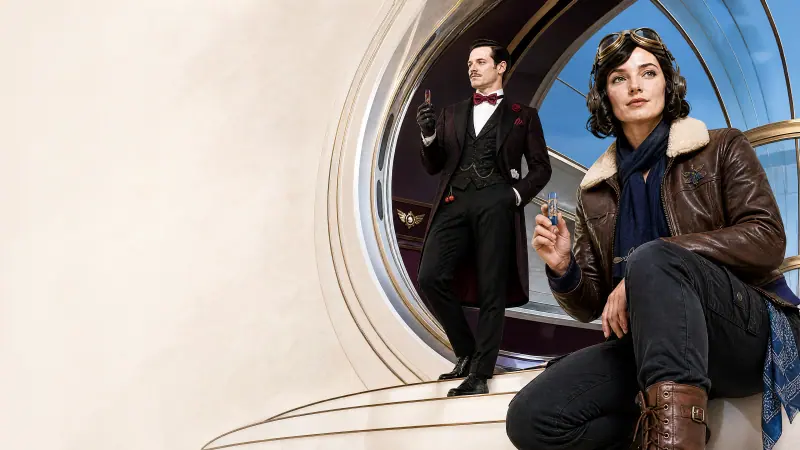 Two AI-generated adult models in vintage tuxedo and aviator jacket inside a white capsule, WINDBAR D91 Voyagers campaign (WindBar.ai)