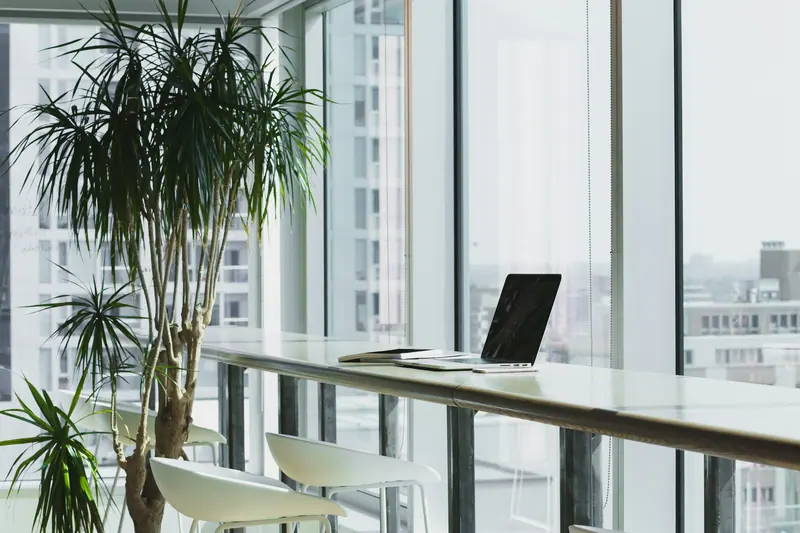 Laptop on a white desk workspace (Unsplash stock) — WindBar.ai D91 Voyagers