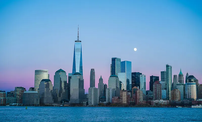 City skyline lights in the evening (Unsplash stock) — WindBar.ai D91 Voyagers