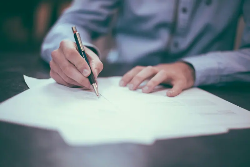 Laptop with paperwork on desk (Unsplash stock) — WindBar.ai D91 Voyagers Source: Photo by Scott Graham on Unsplash (Unsplash License). Not a WindBar product photo.