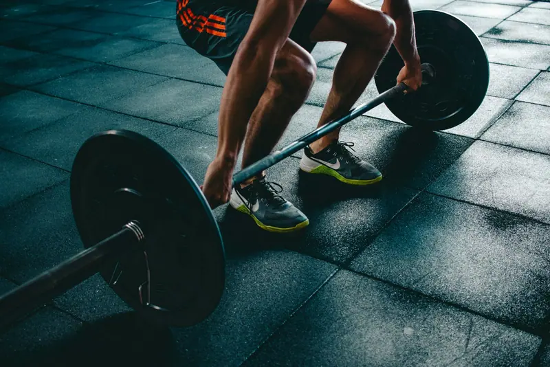 Person holding gym weight plate (Unsplash stock) — WindBar.ai D91 Voyagers