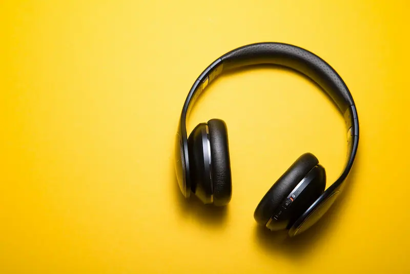 Headphones on yellow background (Unsplash stock) — WindBar.ai D91 Voyagers