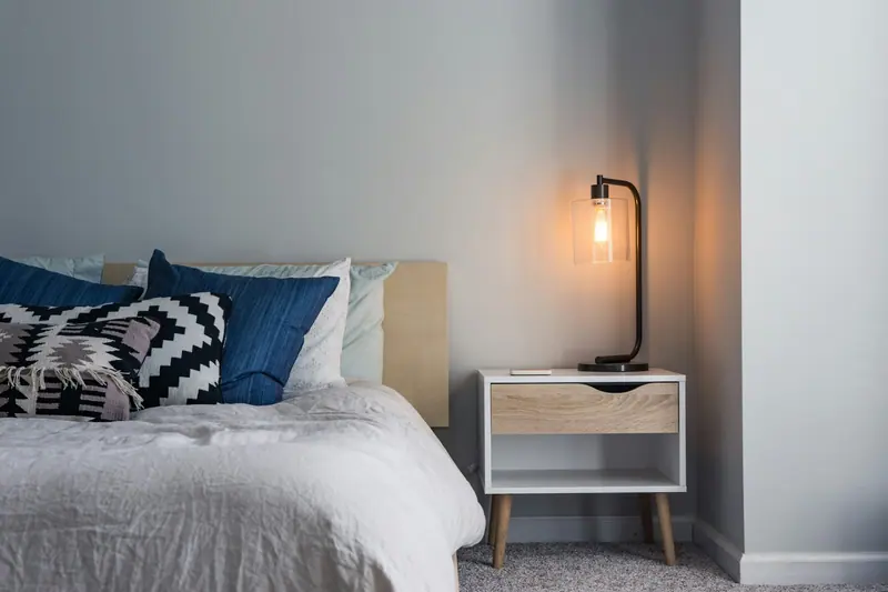 Warm lit bedroom interior (Unsplash stock) — WindBar.ai D91 Voyagers